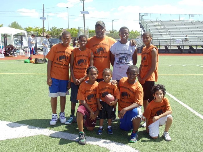 GIVING BACK – College Football Hall of Famer Rich Glover (back row, center) conducted his 11th Annual “All Access to Life Foundation” free football camp at Caven Point Cochrane Field last week. Front row, from left, are Tysaan White, Tyler White, Hasan Dominick and Ivan Zuniga. Back row, from left, are Daivan Lee, Kasaan Brevard, Glover, Tsulu Scrivens and Devin Johnson.